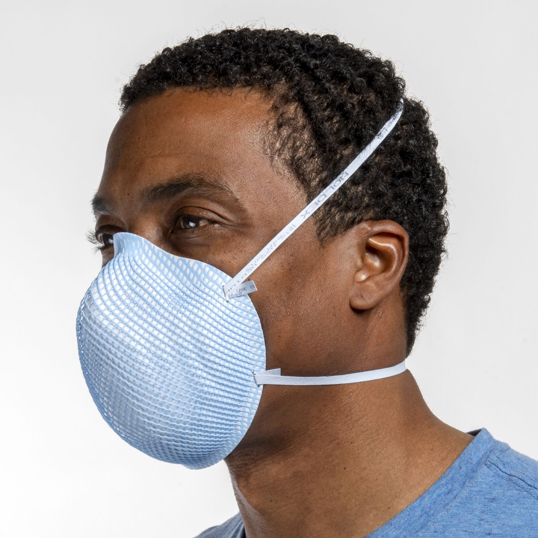 Man healthcare worker wearing blue medium health care NIOSH N95 surgical respirator from Canada Strong Masks.